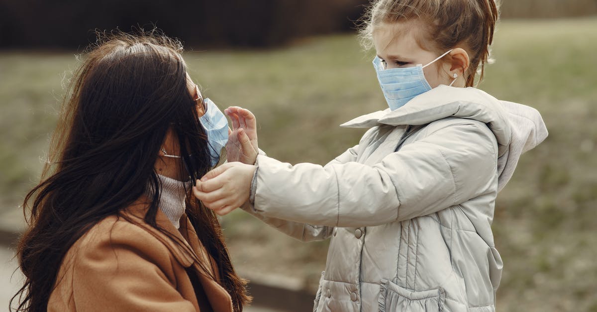 What practices can help me hitchhike safely? [closed] - Cute little girl in mask helping put on medical mask for mom in sunglasses during stroll in park