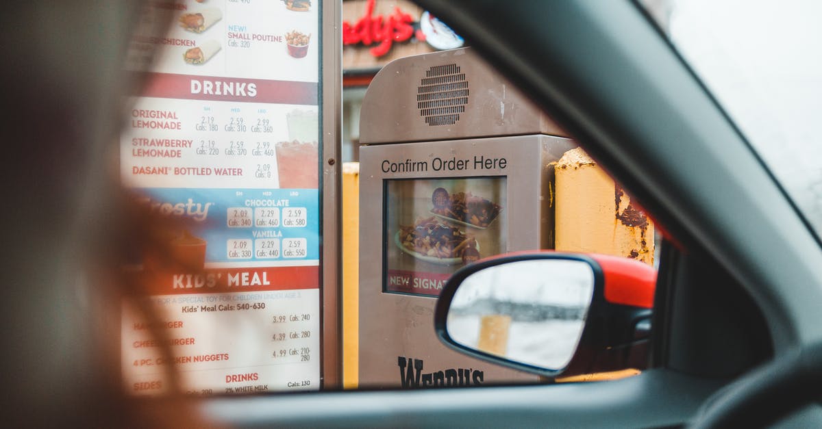 What public transport options exist between Calgary, Banff, and Jasper? - Person ordering fast food in drive thru