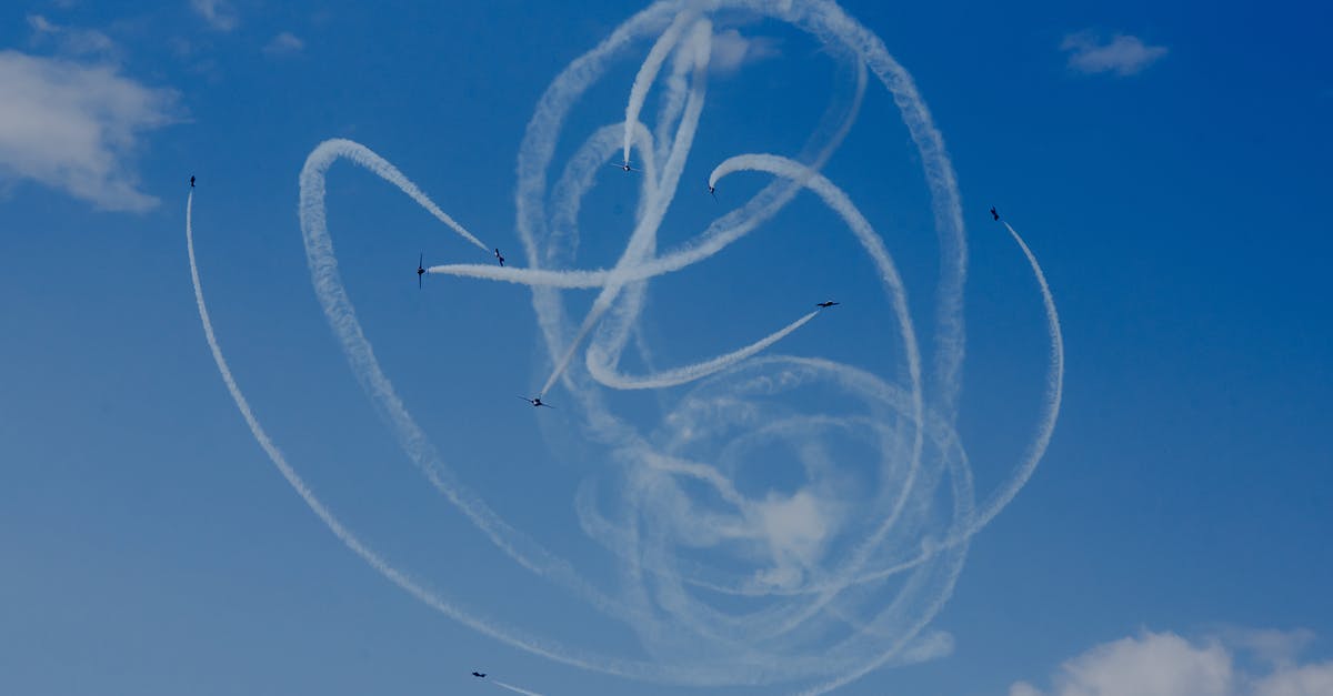 What rules govern forced removal from flights (due to overbooking)? - From below of air tattoo with airplanes demonstrating acrobatic flight with wavy traces in cloudy sky