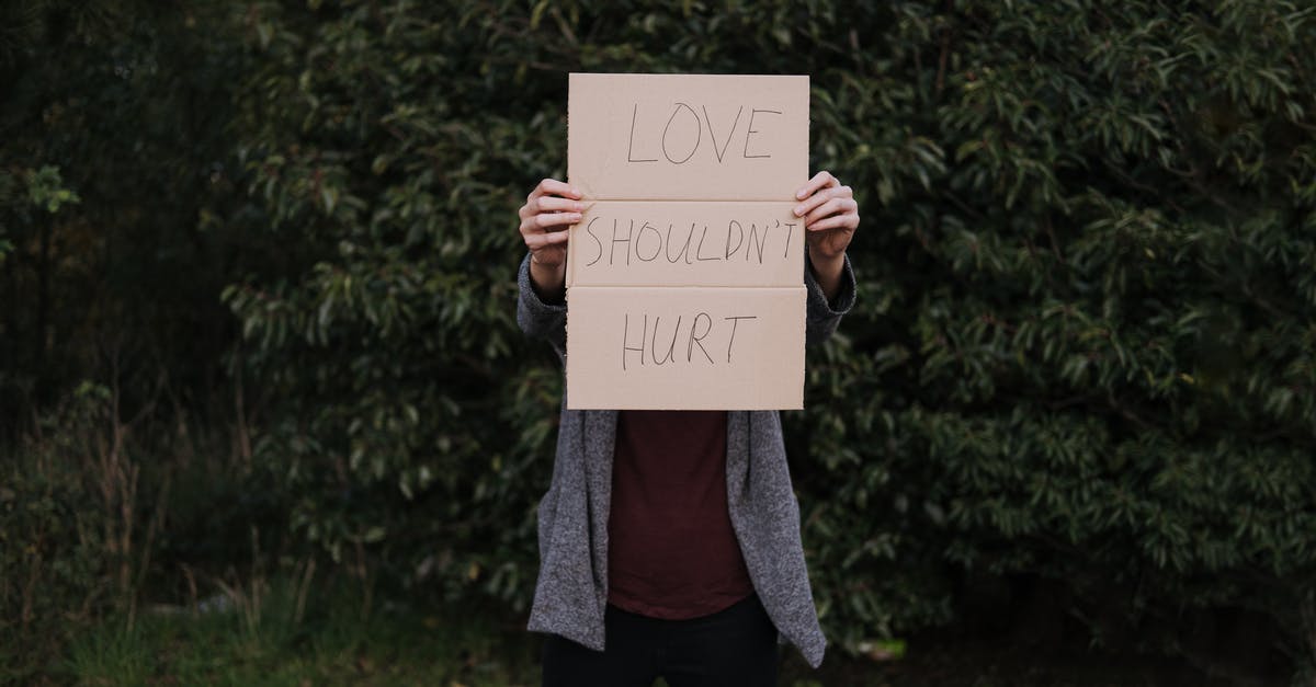 What should I do to avoid ear pain when flying? - Anonymous female with poster about hurtful love in nature