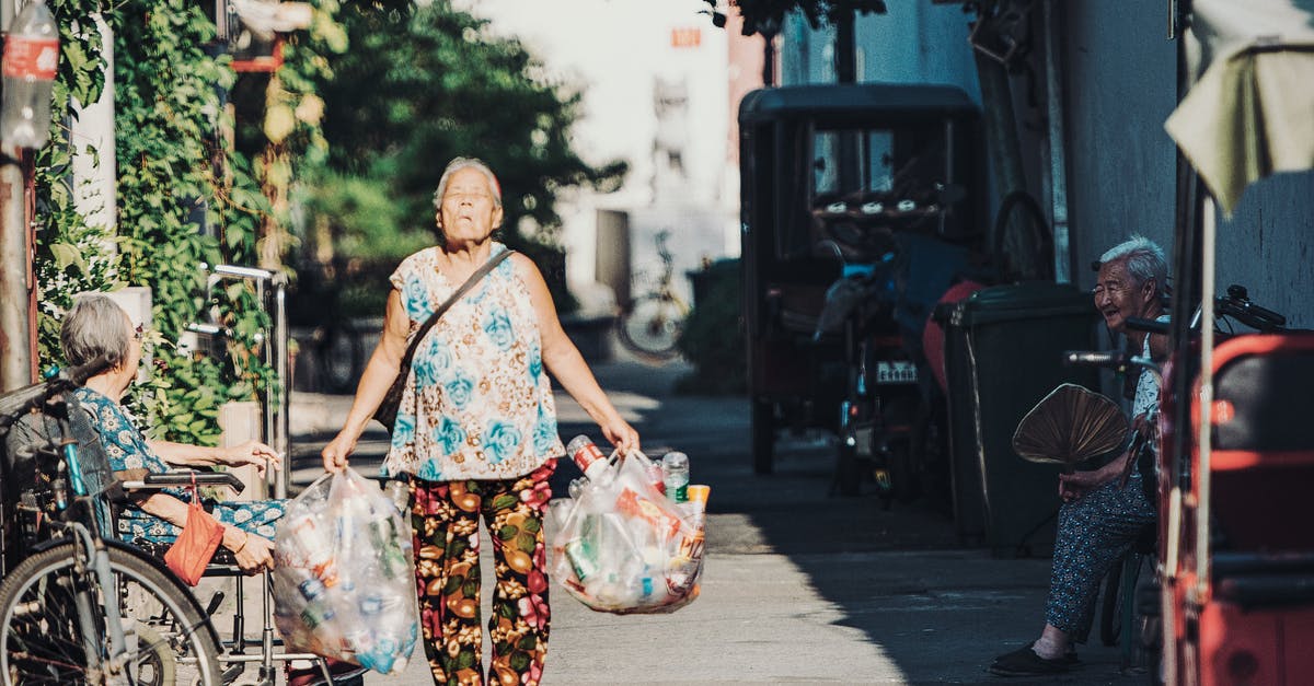 What should I look for in footwear for walking long distances in mostly urban areas while carrying a heavy backpack? - Blue and White Floral Sleeveless Top