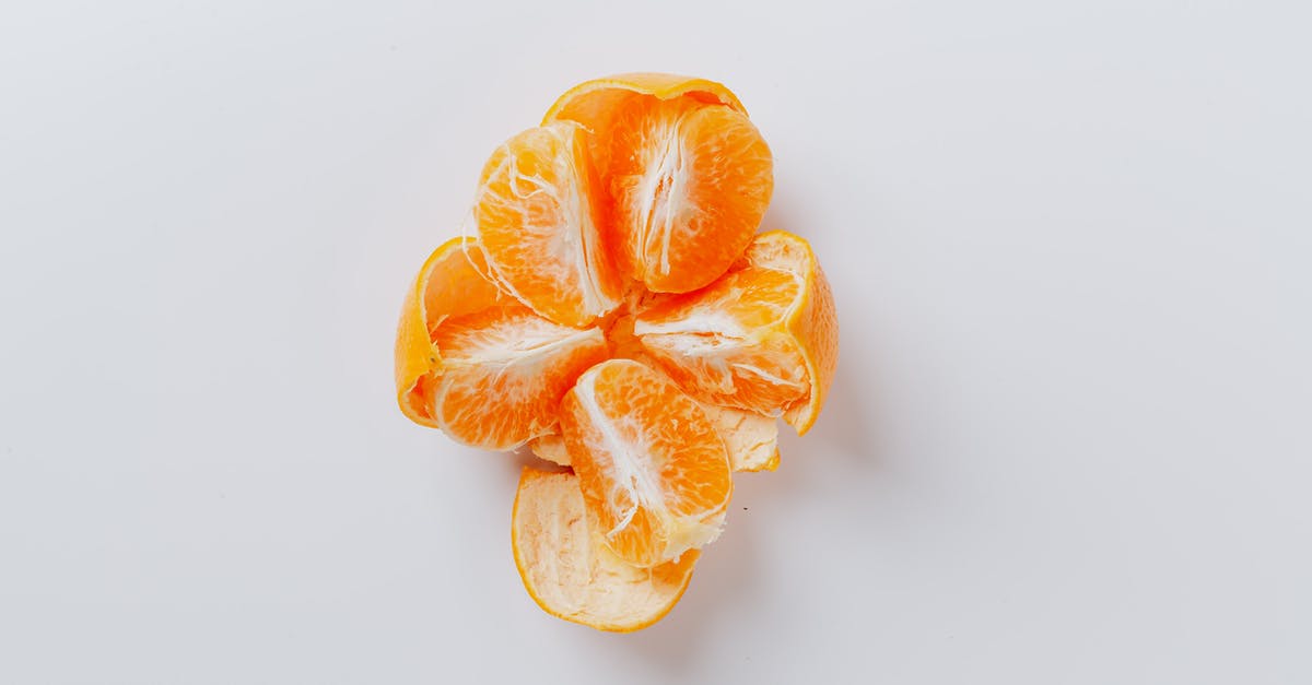 What species of fruit was this orange-like thing with a dark-green peel that I ate in Israel? - From above of fresh peeled juicy tangerine divided into five equal slices on gray background