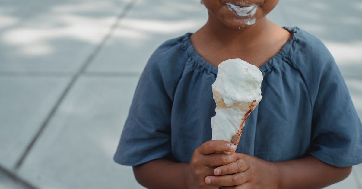 What street foods can I eat in Italy? - Little child with dirty mouth standing with ice cream on street