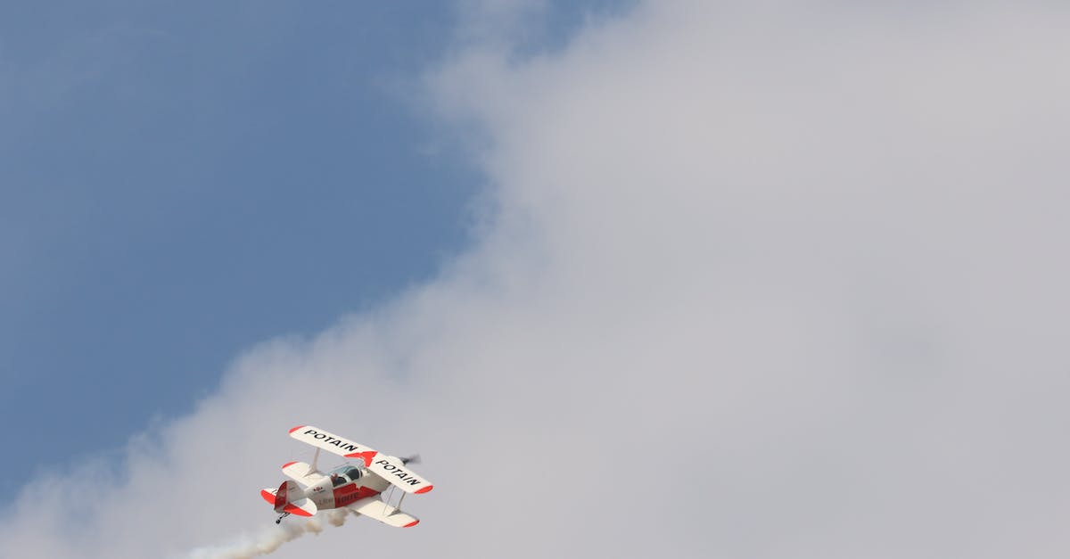 What techniques, tricks or otherwise have you used to get upgrades on flights? - White and Red Biplane Flying during White Cloudy Day