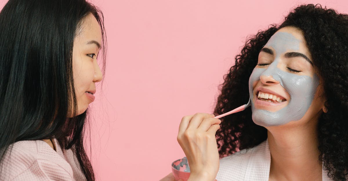 What to do with long facial hair in the onsen? - Woman putting on cosmetic mask on face of other woman