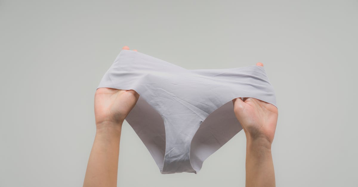 What to do without underwear on a 4 day trip? - Person Holding White Textile