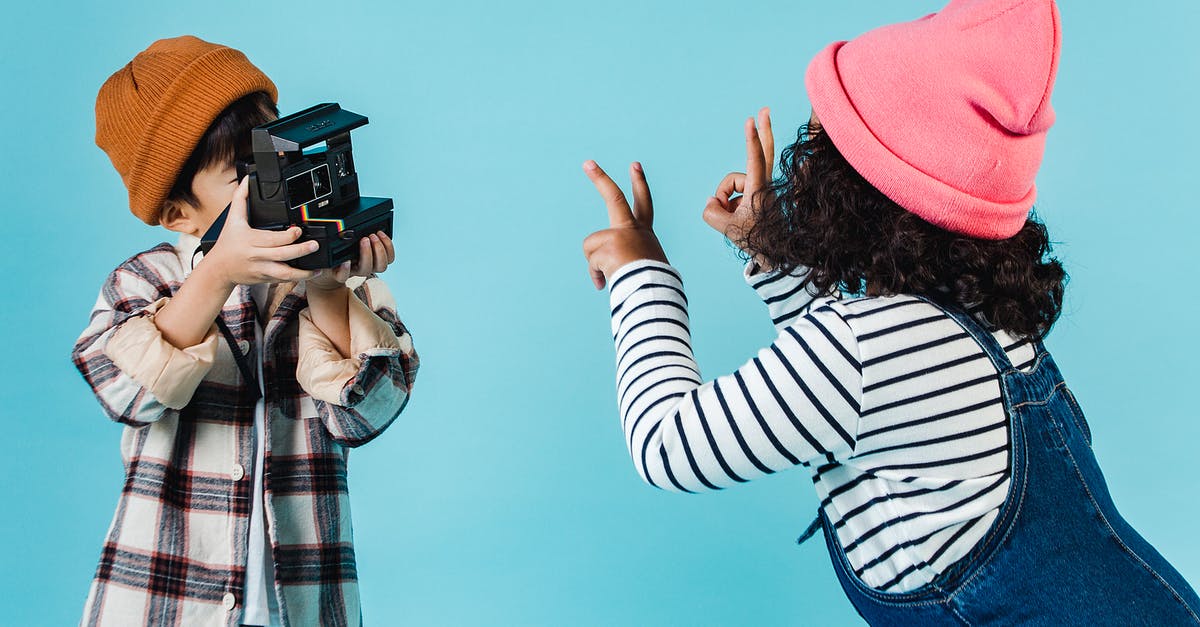 What traffic interchange does this picture show? - Positive diverse children taking photo on instant photo camera