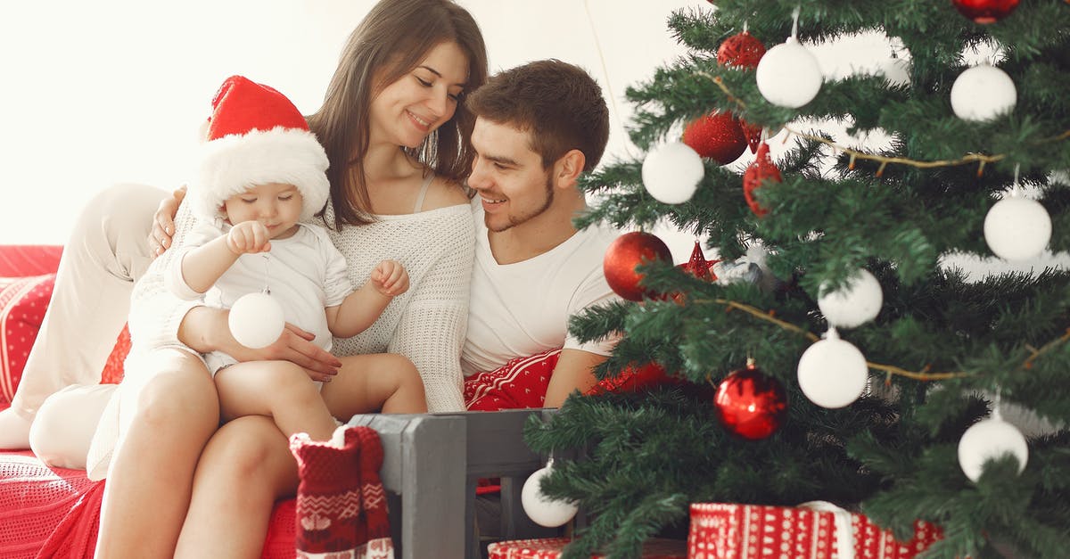 What visa does family need to holiday in New Zealand? - Woman in White Long Sleeve Shirt Sitting Beside Woman in Red Shirt