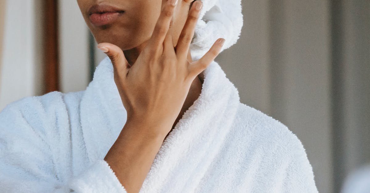 What visa procedures/rules apply in Australia for a Swede 2013? - Crop anonymous female in white bathrobe with towel on head applying facial moisturizing cream on face while standing in bathroom