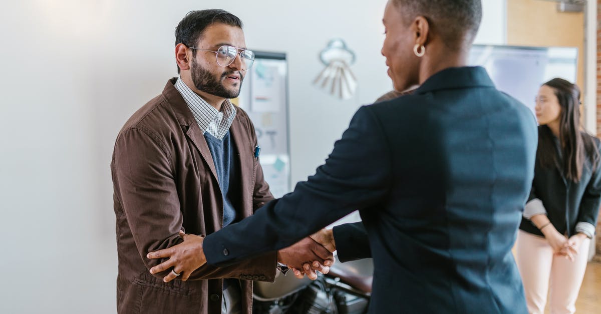 What was the meaning of this Indian gesture/greeting? - A Man and a Woman Shaking Hands Doing Business