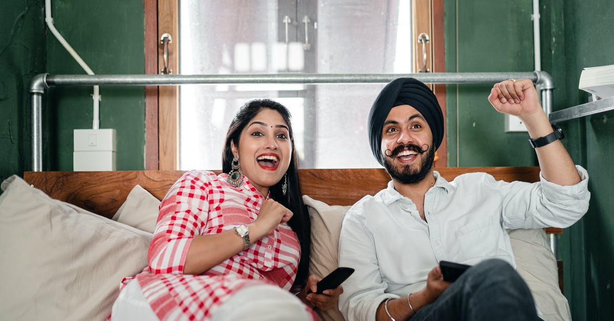 What was the meaning of this Indian gesture/greeting? - Young ethnic couple with remote control lounging in bedroom