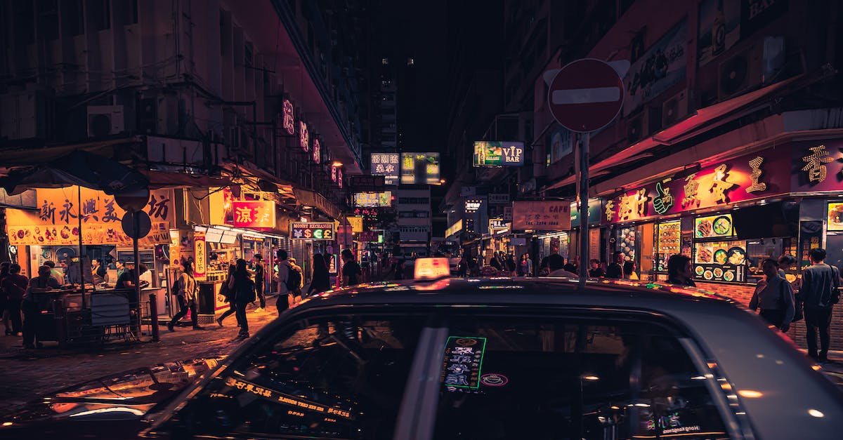 What would be the cheapest public transportation deal for me in Hong Kong? [closed] - Photo of Taxi Near Buildings During Nighttime
