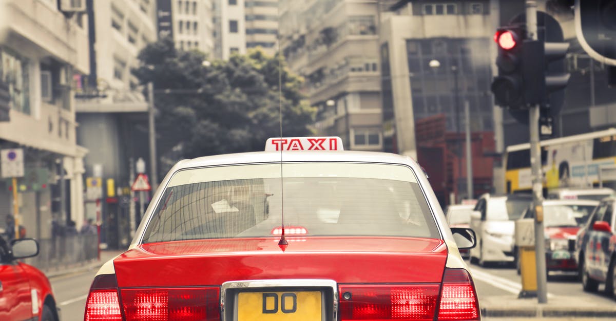 What would be the cheapest public transportation deal for me in Hong Kong? [closed] - Red and White Taxi on Road