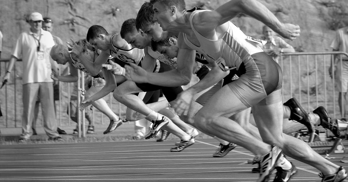 When does an NHL game actually start? - Athletes Running on Track and Field Oval in Grayscale Photography