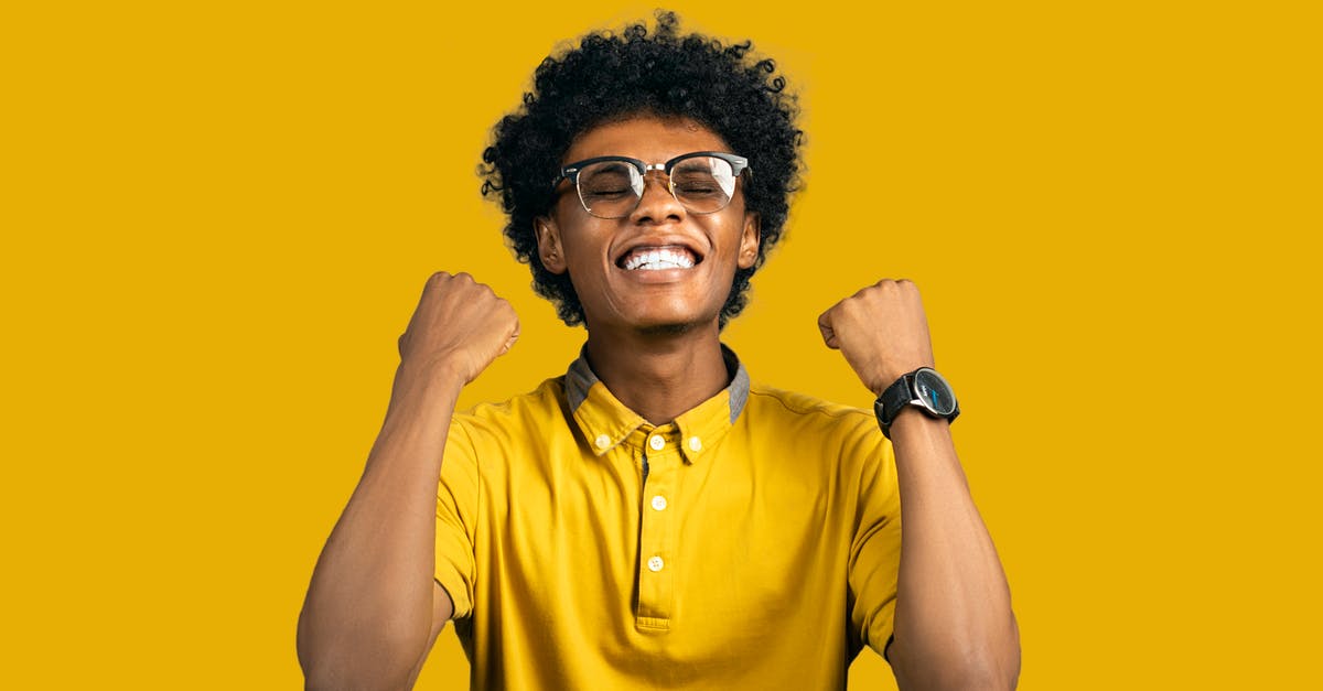 When in doubt, can't you just show two passports? [closed] - Excited African American man with accessories showing yes gesture