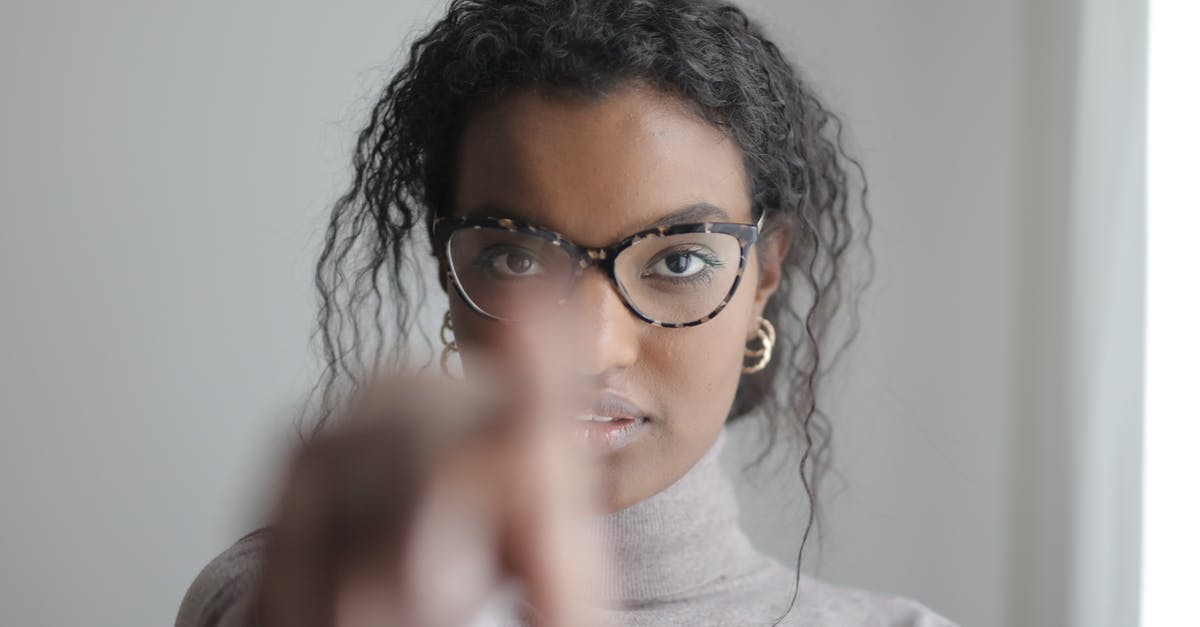 When in doubt, can't you just show two passports? [closed] - Young ethnic woman pointing at camera