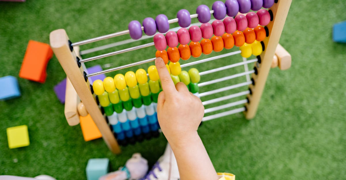 When to count children as guests? - Child Playing With An Abacus and Learning To Count