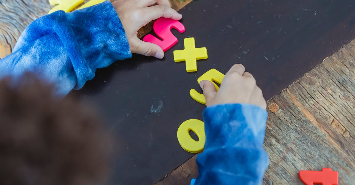 When to count children as guests? - Ethnic boy solving mathematical example made of toy numbers