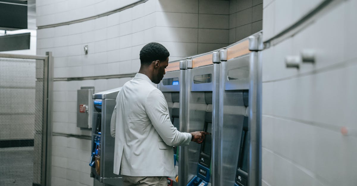 When transferring from non-Schengen EU airport to a Schengen airport, do I need to go through security at the connection airport? - Man in White Dress Shirt and Gray Pants Standing in Front of Glass Door