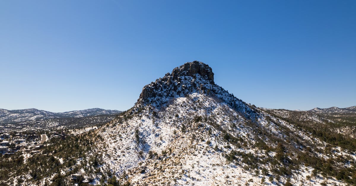 When travel insurance covers natural disasters - White and Green Trees on Mountain Under Blue Sky