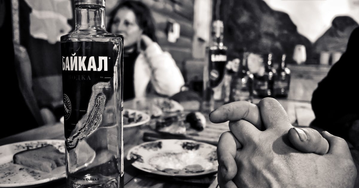 When you bring someone to a restaurant in Russia - Grayscale Photography of Bottle Beside Saucer