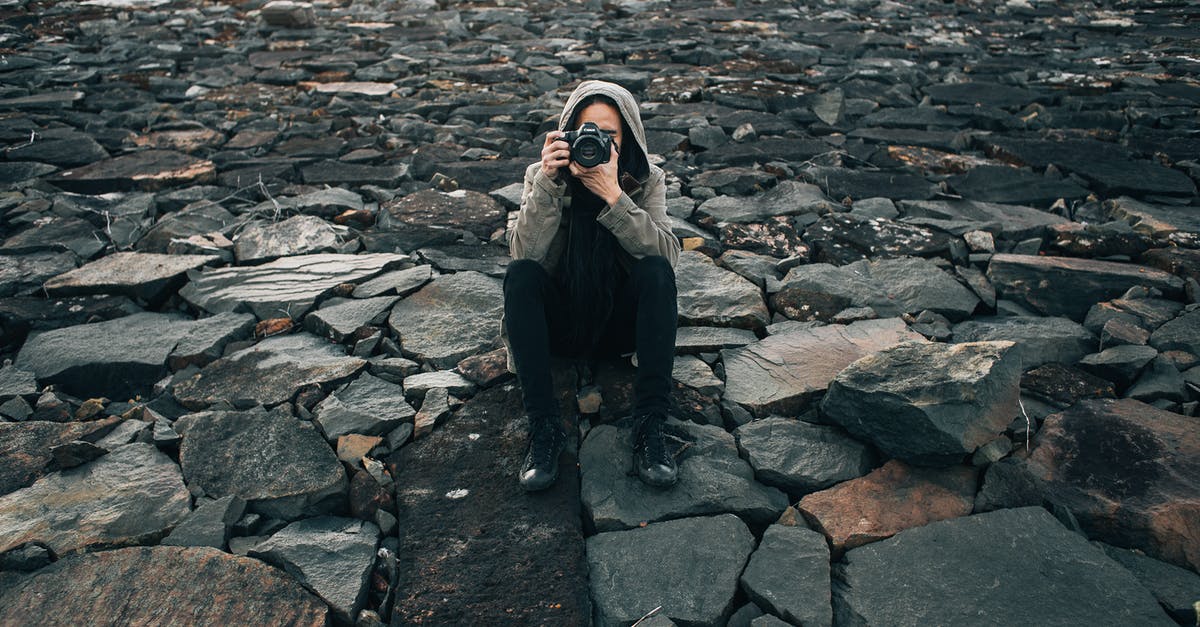 Where's this picture of a glacial moraine in autumn taken? - Concentrated photographer taking picture on stones