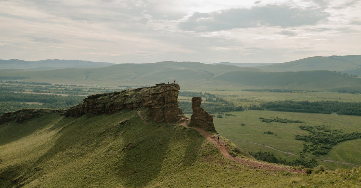 Where's this verdant ridge? - Peaceful verdant fresh fields and hills with green bushes and rocky terrain in summer