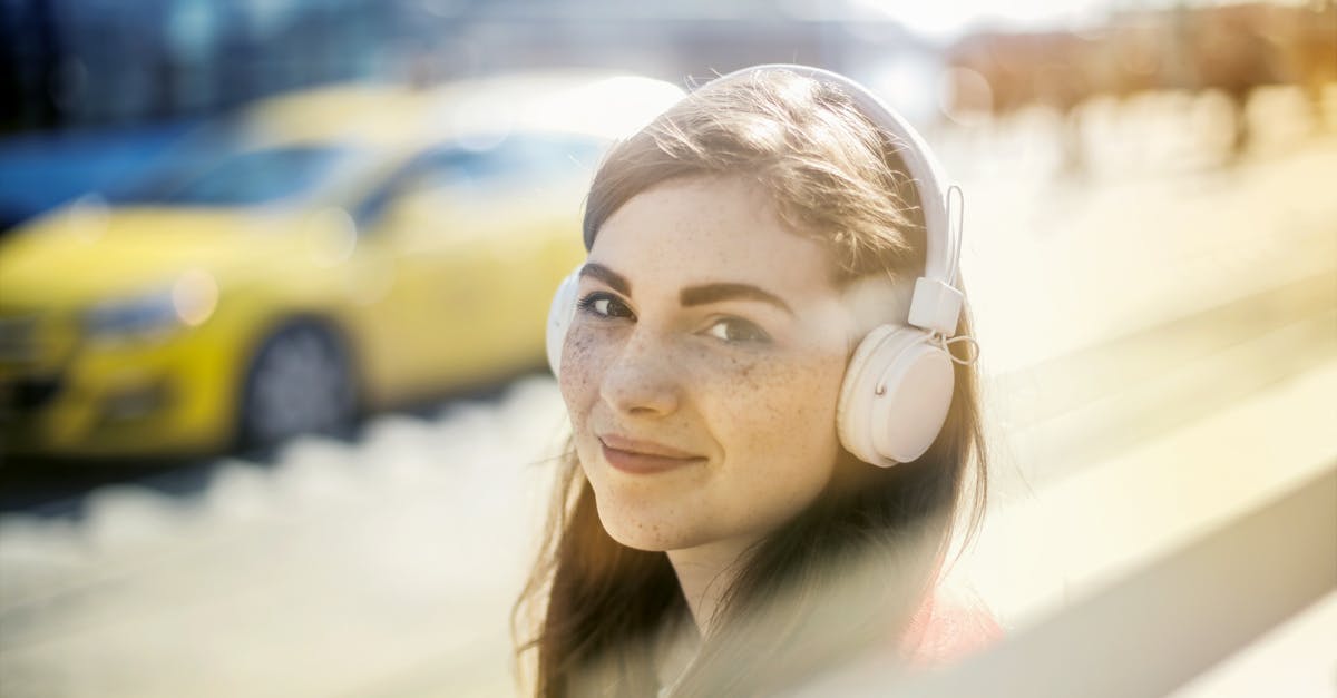 Where are the melody roads located in Gunma prefecture? - Happy young woman in headphones listening to music on street