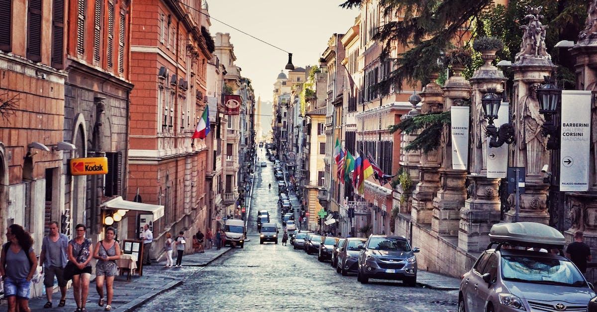 Where are the shopping areas in Rome? - A Busy Street with Cars and People