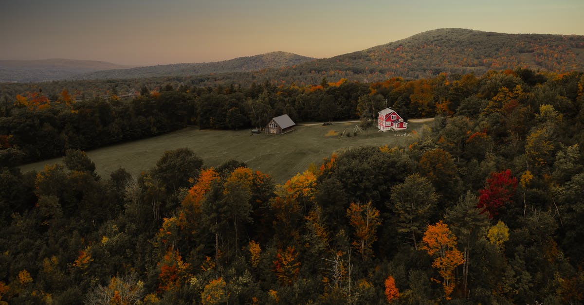 Where are these two hills with fall foliage in Saguenay QC? - Farm cottages amidst autumn trees at sunset