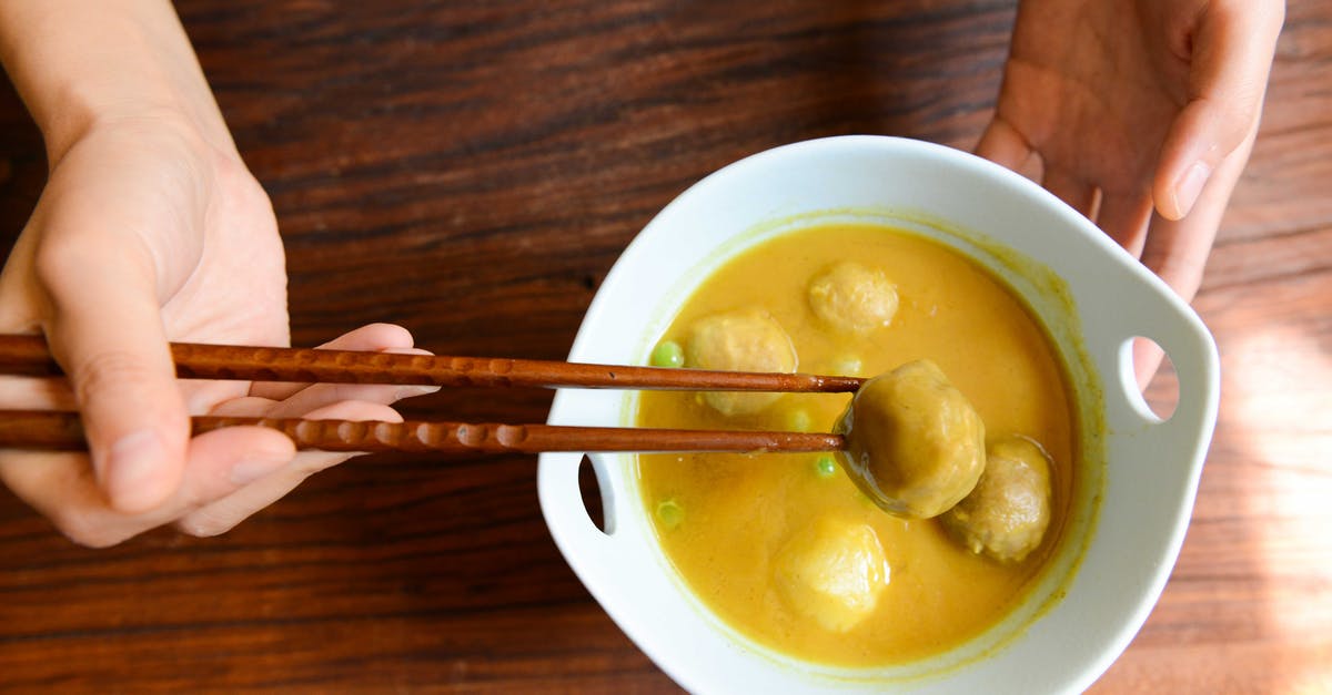 Where can I eat turtle excrement soup? - Person Holding Chopsticks and White Ceramic Bowl