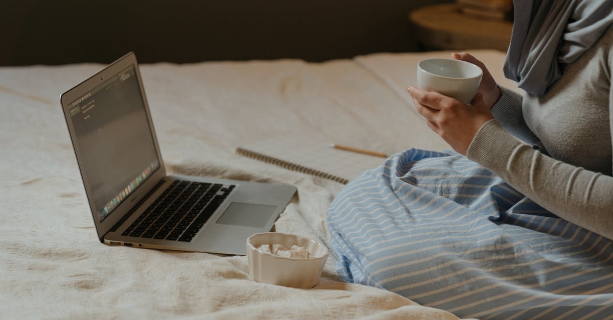 Where can I find the GWR web chat? - Woman in White and Blue Striped Dress Shirt Using Laptop