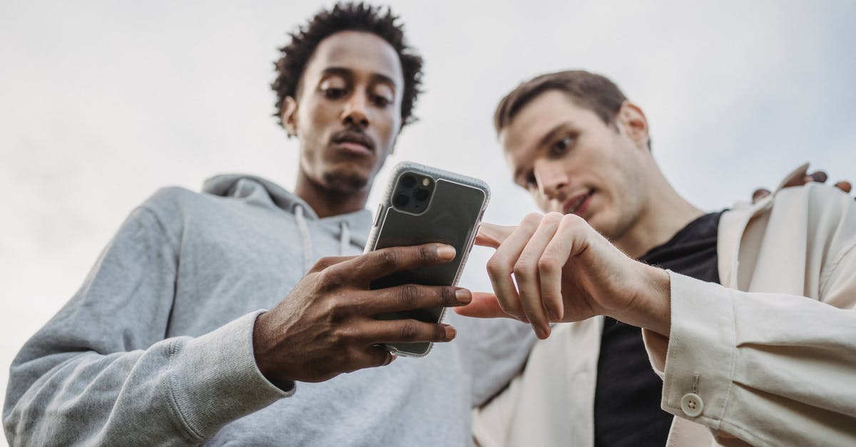 Where can I go and watch Flamenco shows in Istanbul? - Multiethnic friends browsing smartphone together outside