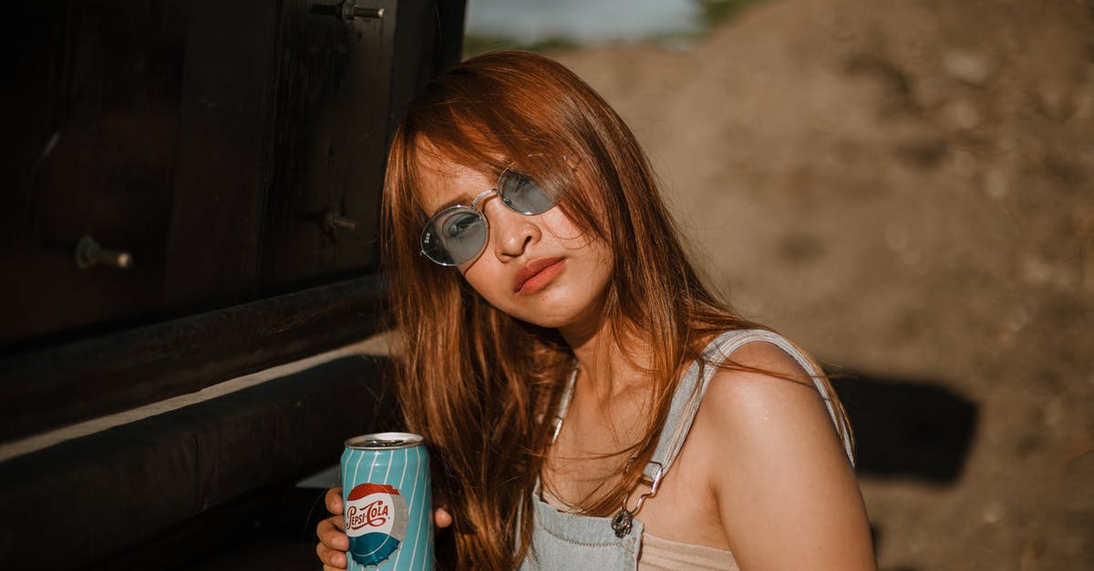 Where can I go looking for amber in Gdańsk, Poland? - Woman Holding Soda Can