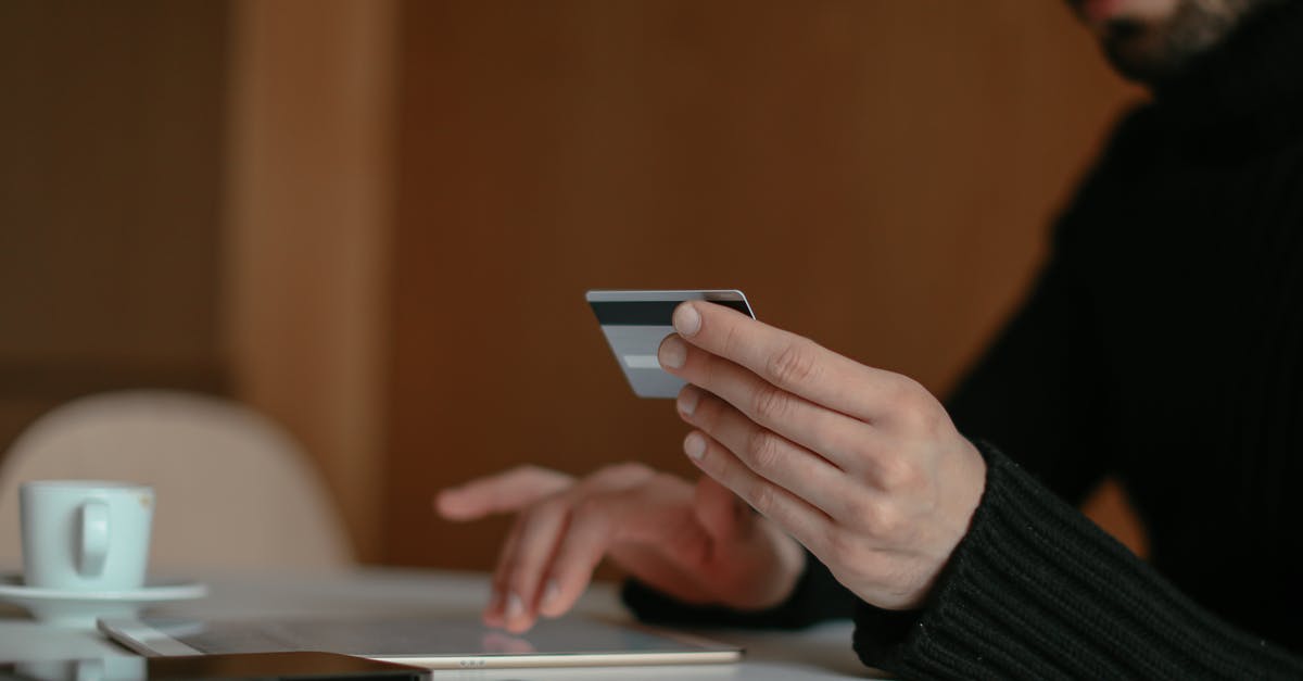 Where can I purchase anti venoms? - Close up of a Man Using a Bank Card Online