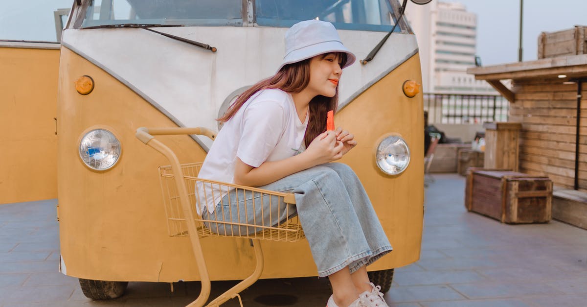 Where can I ride a pump trolley? - Delighted Asian female with watermelon near retro van