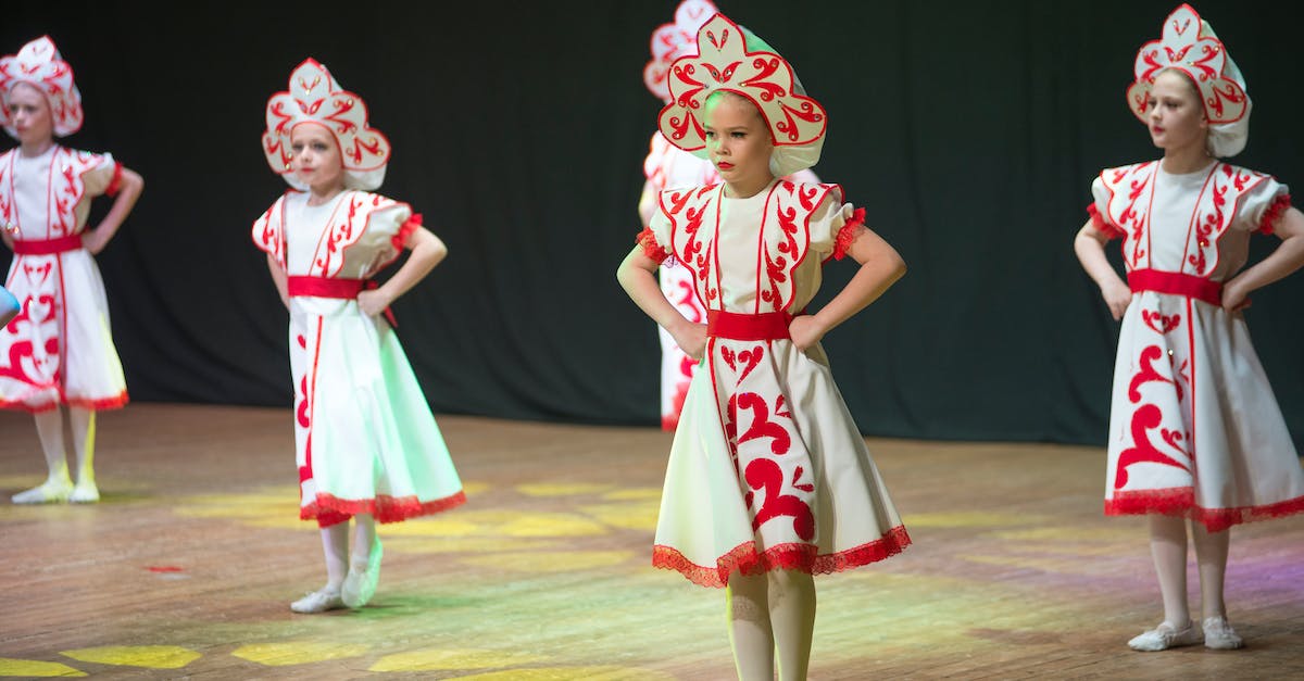 Where can I see a Mbalax performance in Dakar? - 2 Girl in Red and White Dress Standing on Green Field