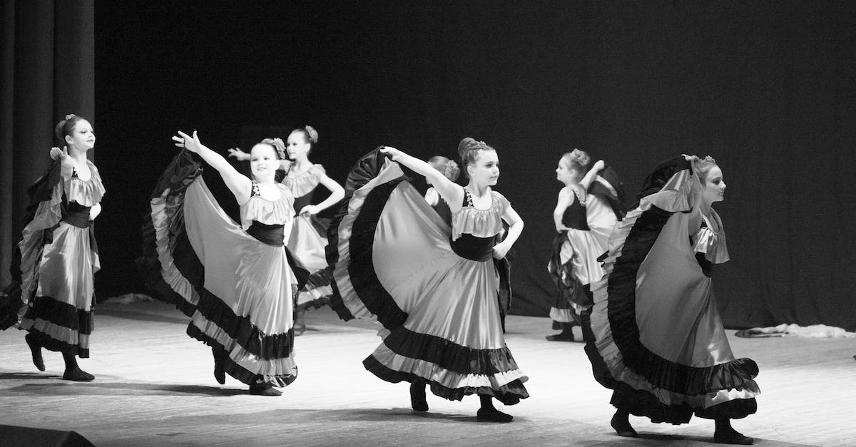 Where can I see a Mbalax performance in Dakar? - Grayscale Photo of Women Dancing