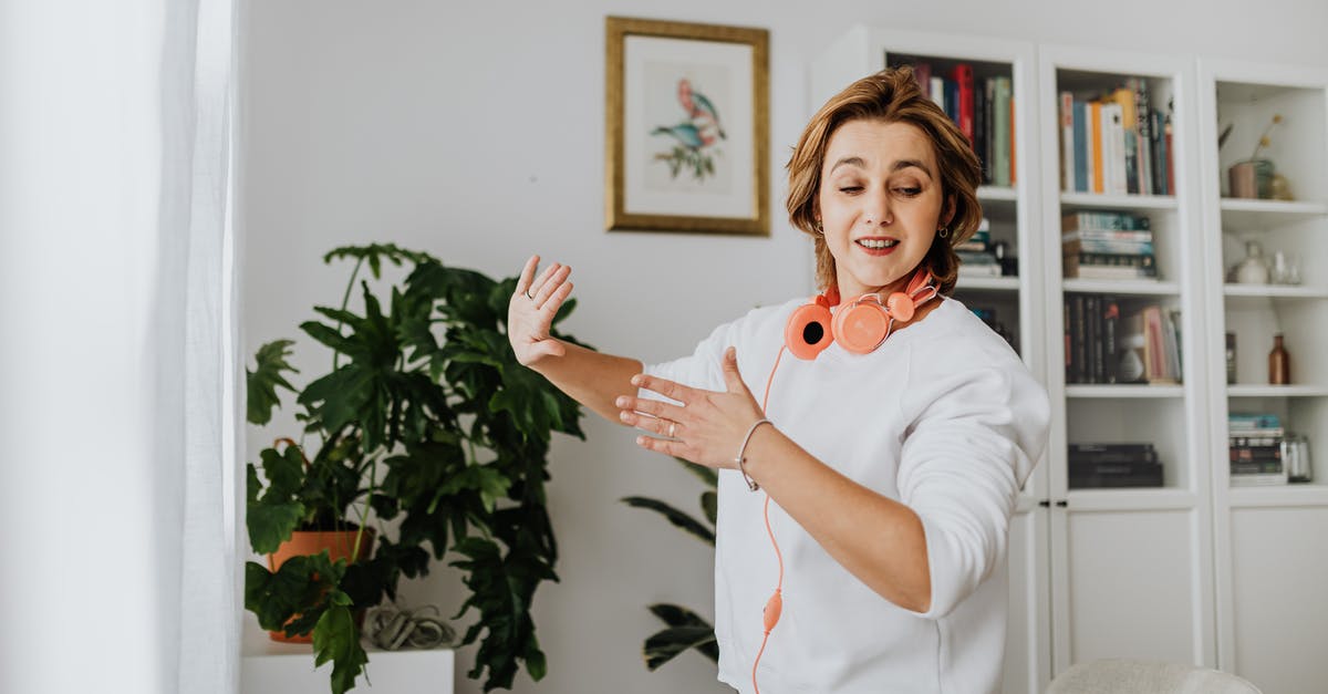 Where can I see folk music and dancing in Moldova? - Smiling Woman Dancing in the Living Room