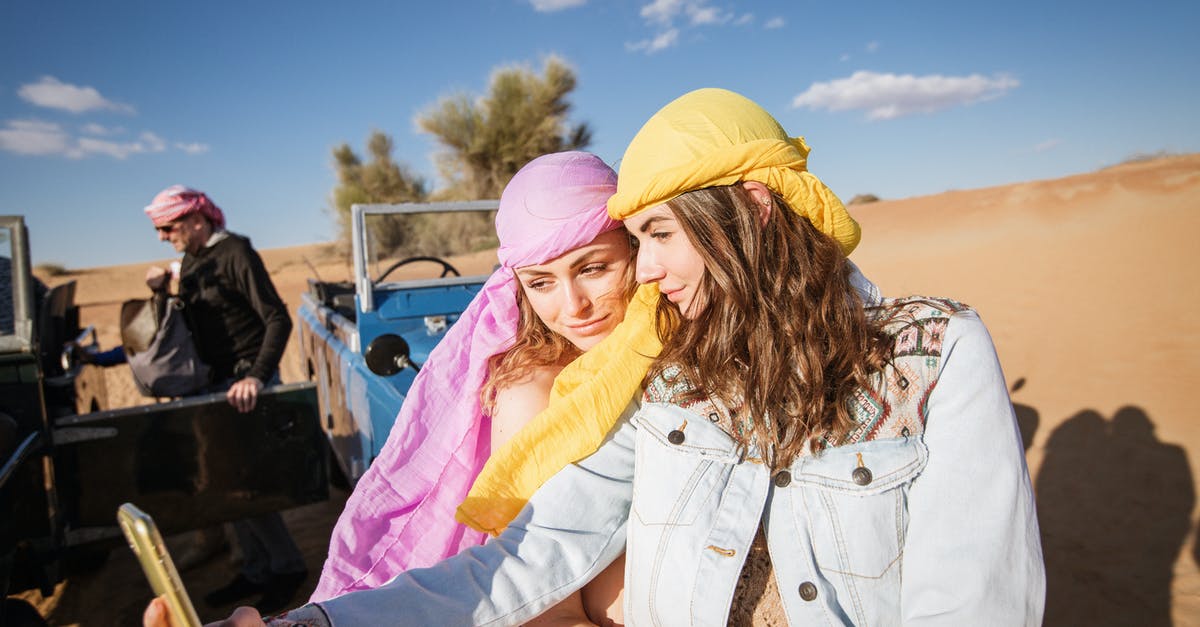 Where can I take a shower at Dubai Airport? - Two Women Wearing Head Scarf Taking Selfie Together