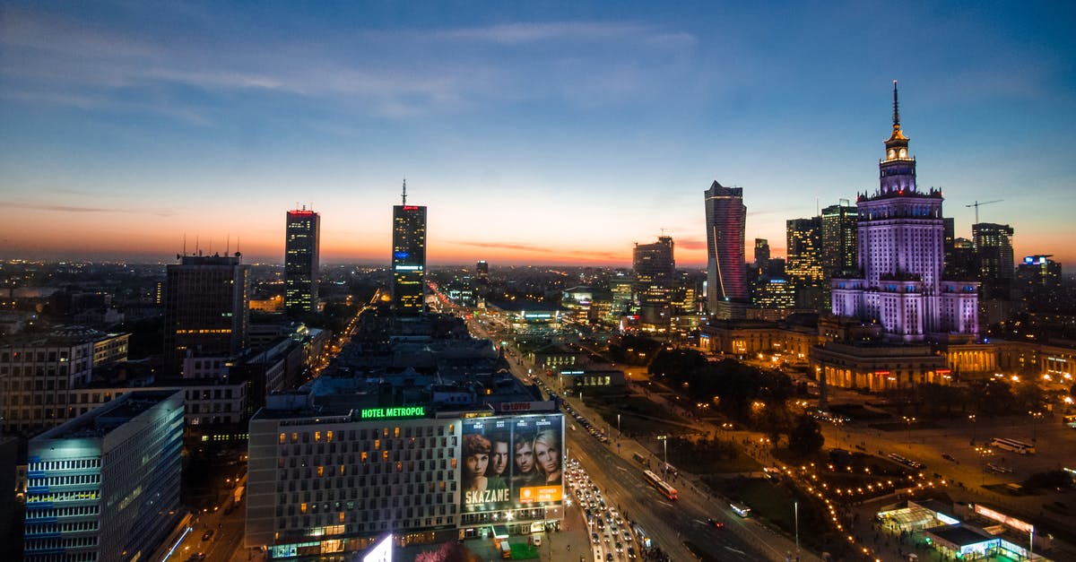 Where can I take the photos of Warsaw Skyline at night? - High-rise Buildings Under Blue Sky