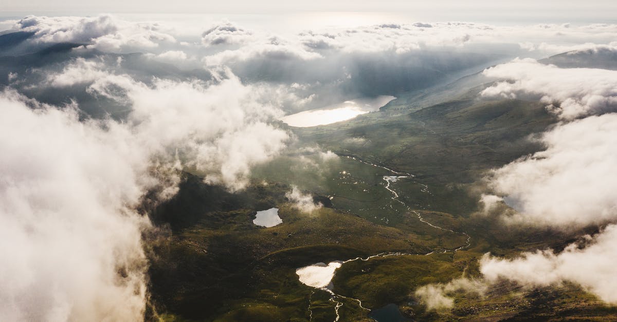 Where can I visit Anthony Howe's amazing wind-powered kinetic sculptures? - Aerial View Photo of Rivers and Mountain