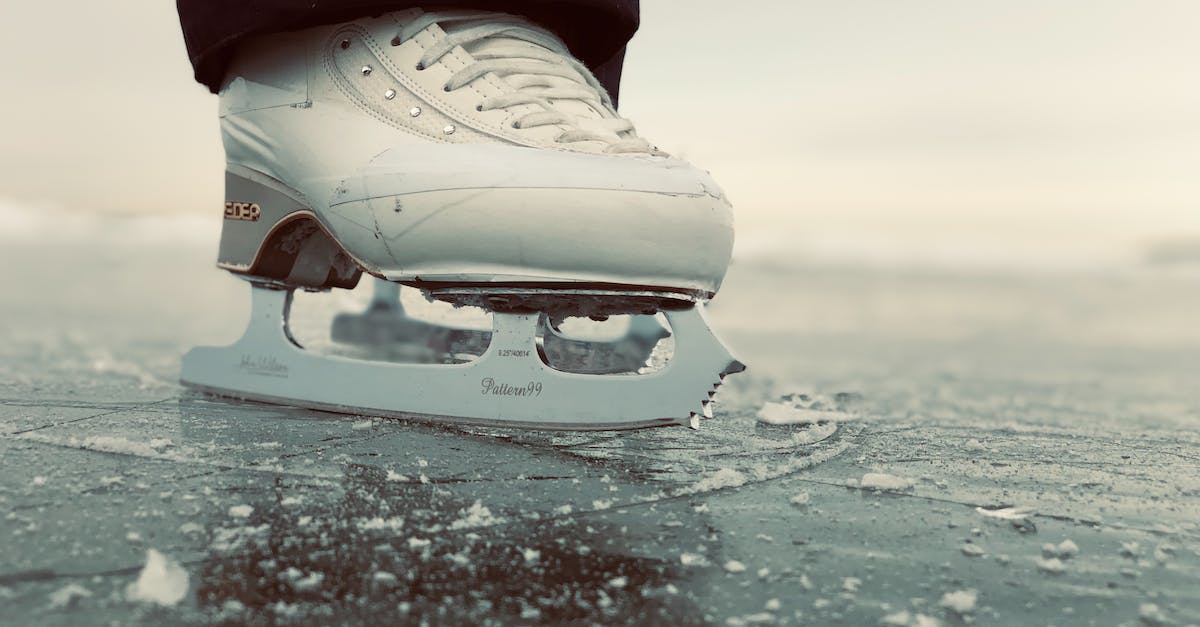 Where can you go lake ice skating in Southern Sweden? - Person in Red Pants and White Sneakers Standing on White Surfboard