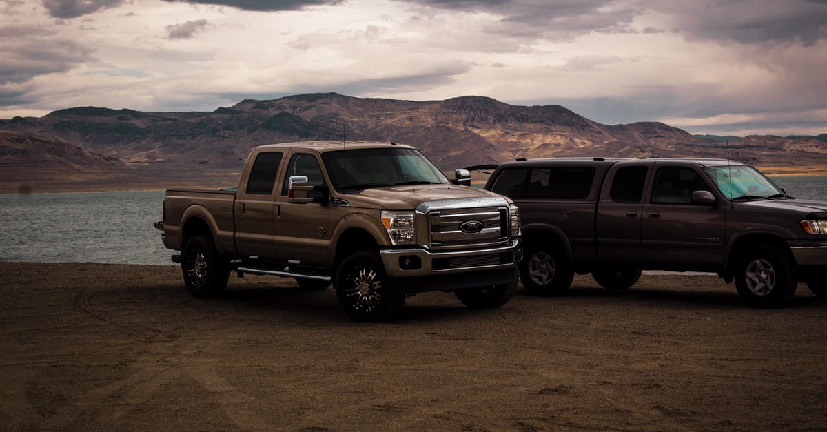 Where do I pick up an Enterprise rental car at EWR? - Photography of Vehicles Near Lake