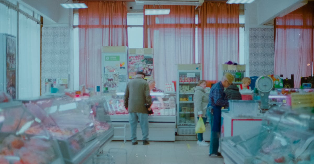 Where do the locals in Rhodes do their groceries? - Small Group of People Doing Shopping in Local Store