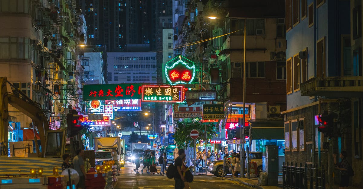 Where exactly is this cross in Hong Kong? - People Crossing Street during Nighttime