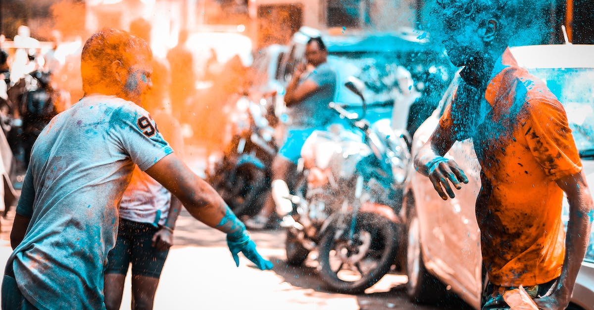 Where in India can one wash and play with elephants? - Joyful people throwing colored powders while celebrating Holi festival