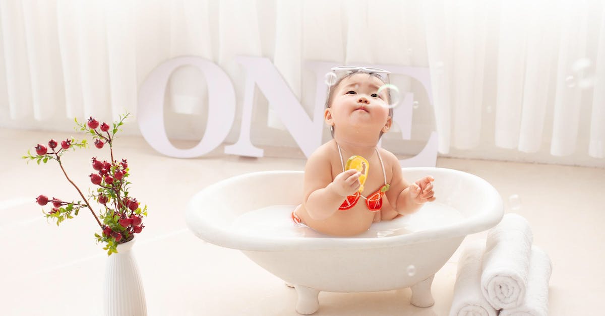 Where in India can one wash and play with elephants? - Adorable ethnic little girl in bathtub