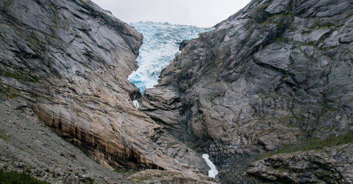 Where in Norway are these massive boulders? - Rough rocky mountain covered with snow near river