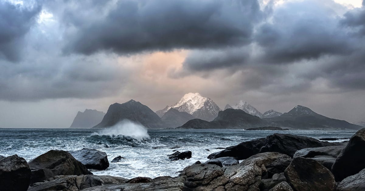 Where in Norway are these massive boulders? - Waves Crashing on Rock Near Mountains during Datyime